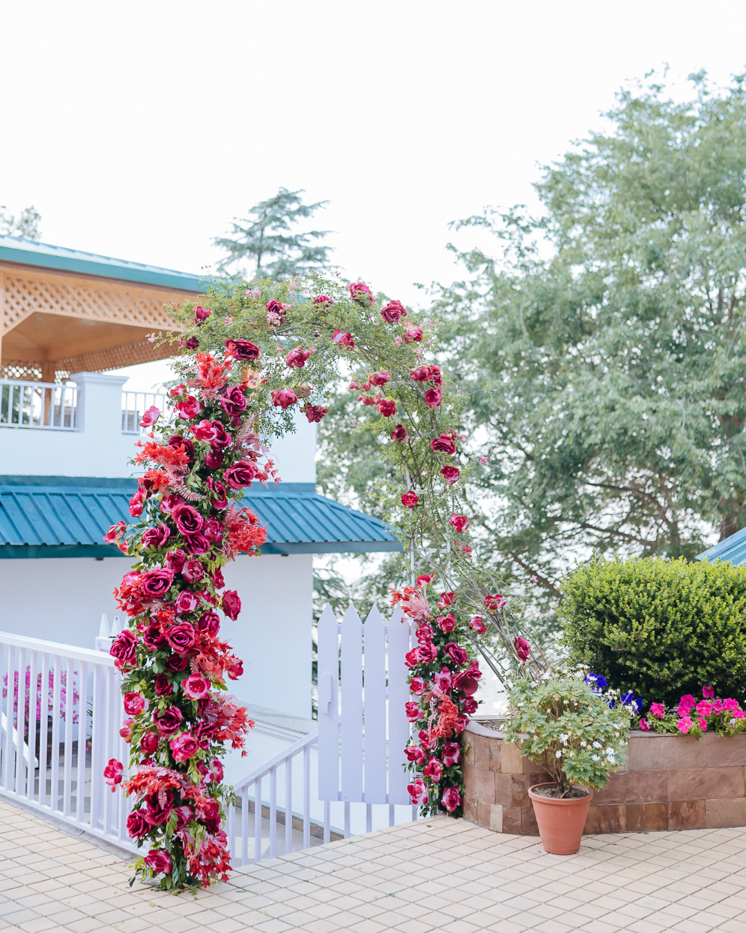 Wedding day floral arch with roses amidst Himalayan greenery for an intimate wedding of 30 people at Daleside Manor, Kasauli.