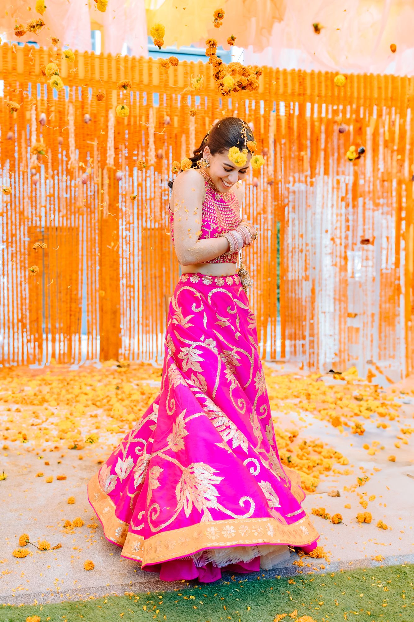 Colourful flower petals raining over Shorye and Leah during the Haldi at Tivoli Chattarpur