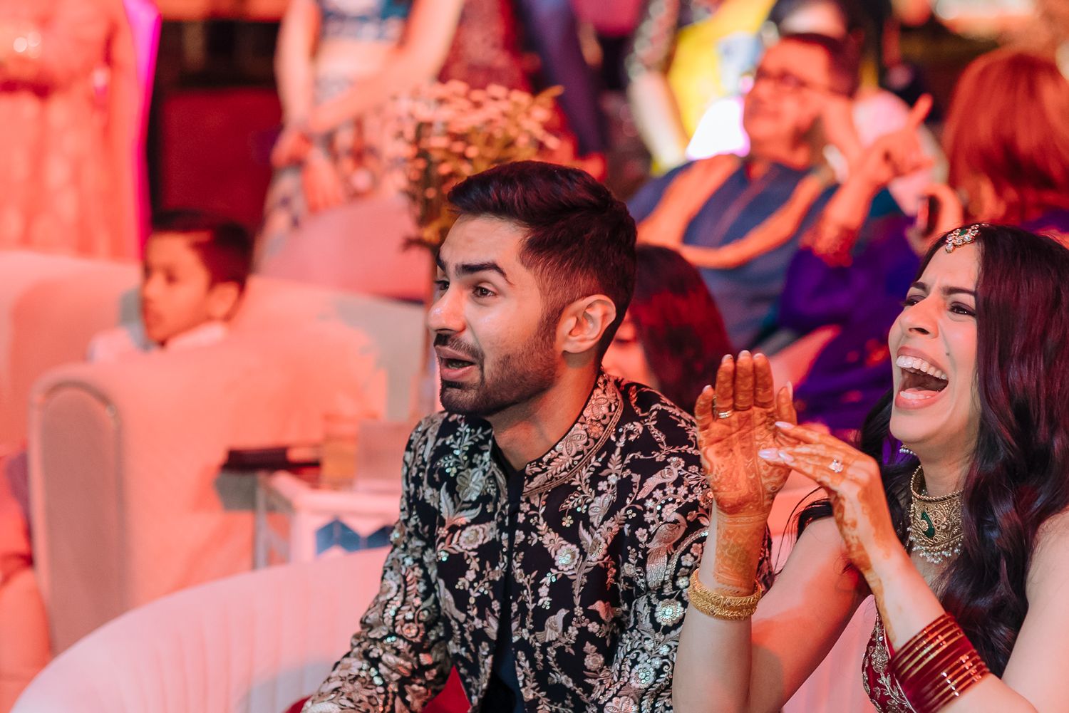 Shorye and Leah cheering for their family during the Sangeet at Tivoli Chattarpur