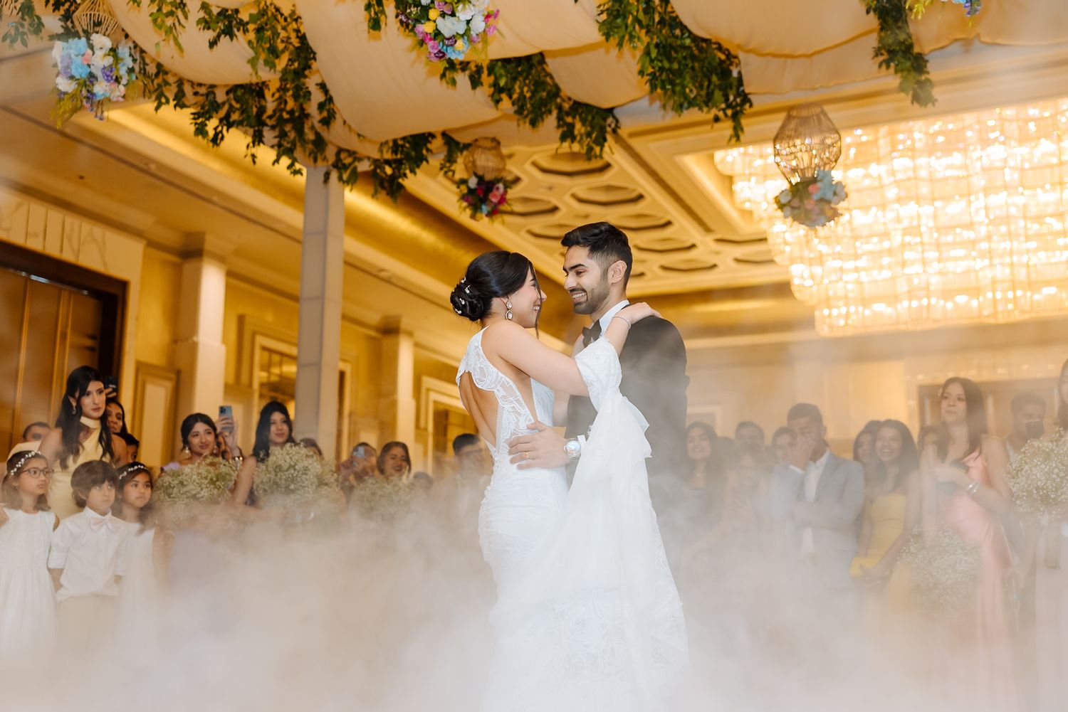 Newlyweds Shorye and Leah enjoying their first dance surrounded by loved ones, after the christian wedding ceremony at Tivoli Chattarpur