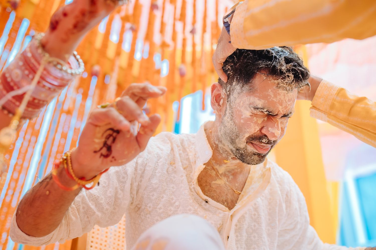 Shorye and Leah sharing a candid Haldi moment with their wedding guests at Tivoli Chattarpur
