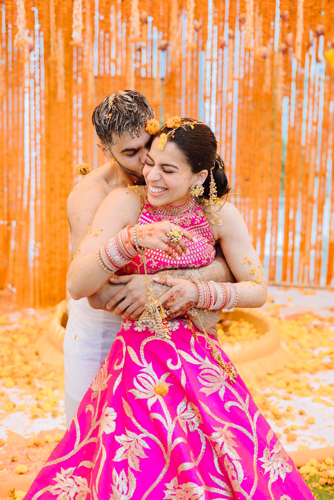 Colourful flower petals raining over Shorye and Leah during the Haldi at Tivoli Chattarpur
