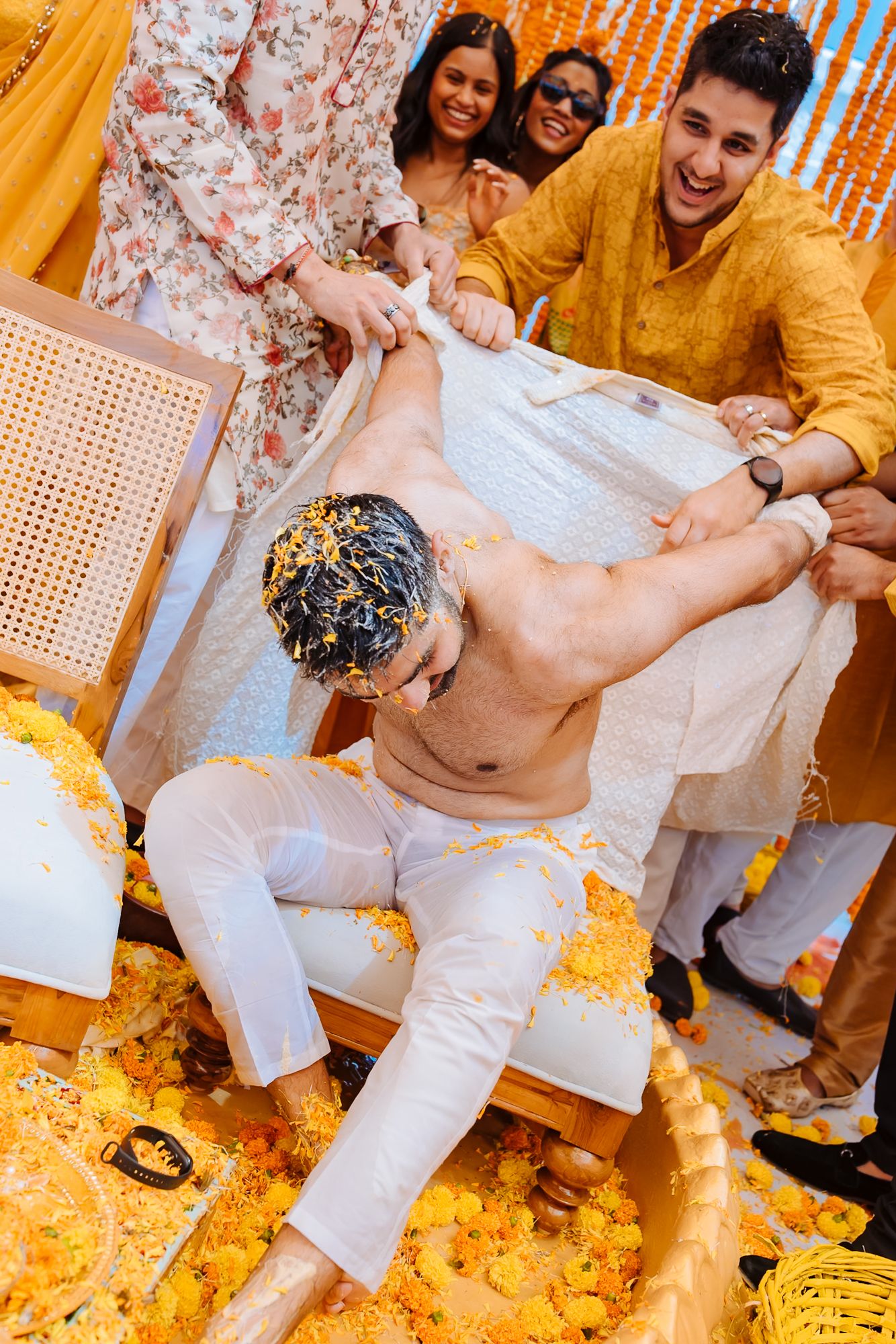 Shorye surrounded by family as they pull apart his kurta during the Haldi at Tivoli Chattarpur