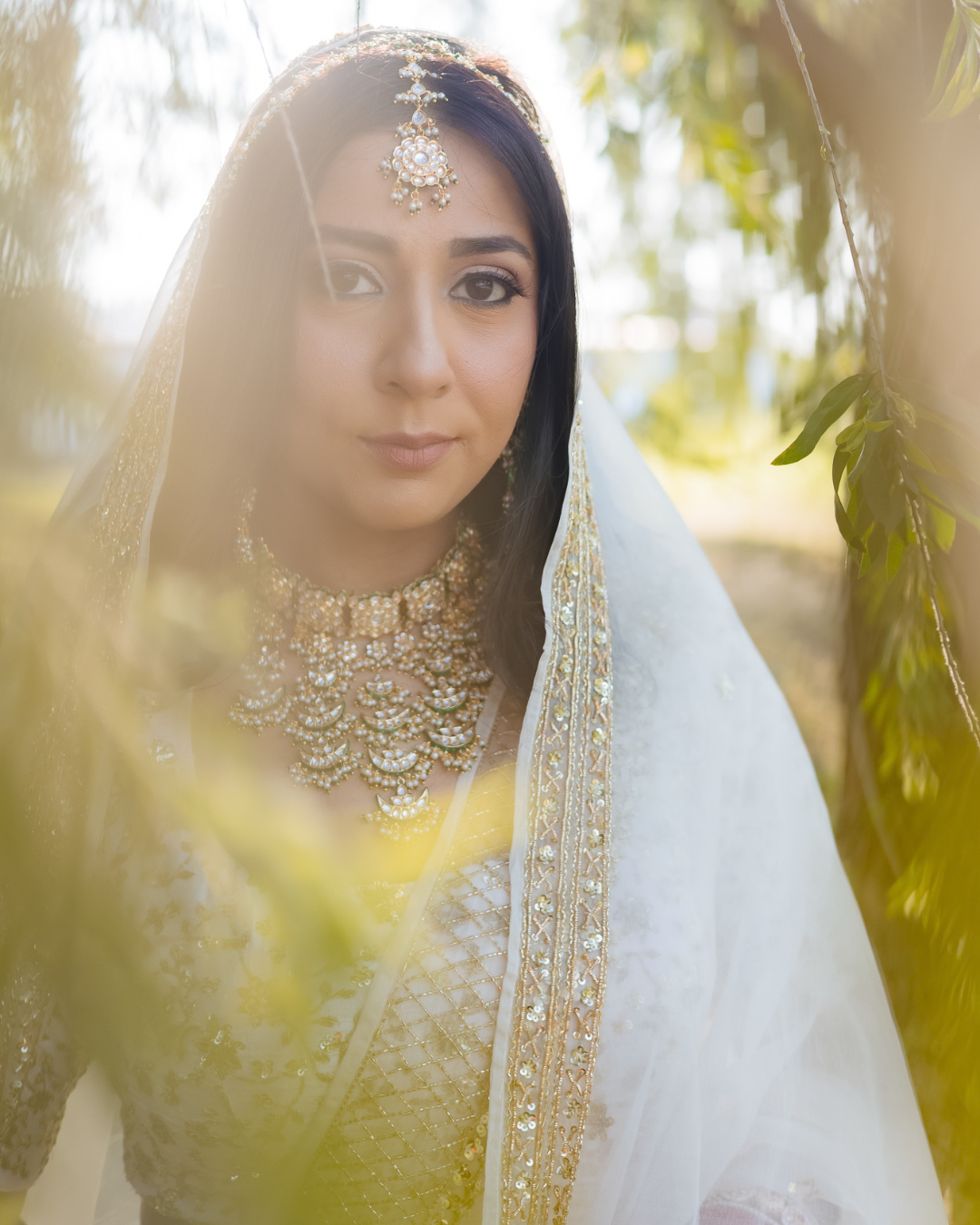 Elegant bridal portrait of Bride Itisha in an ivory lehenga for an intimate Indo-Norwegian wedding in Forest Hill, Chandigarh