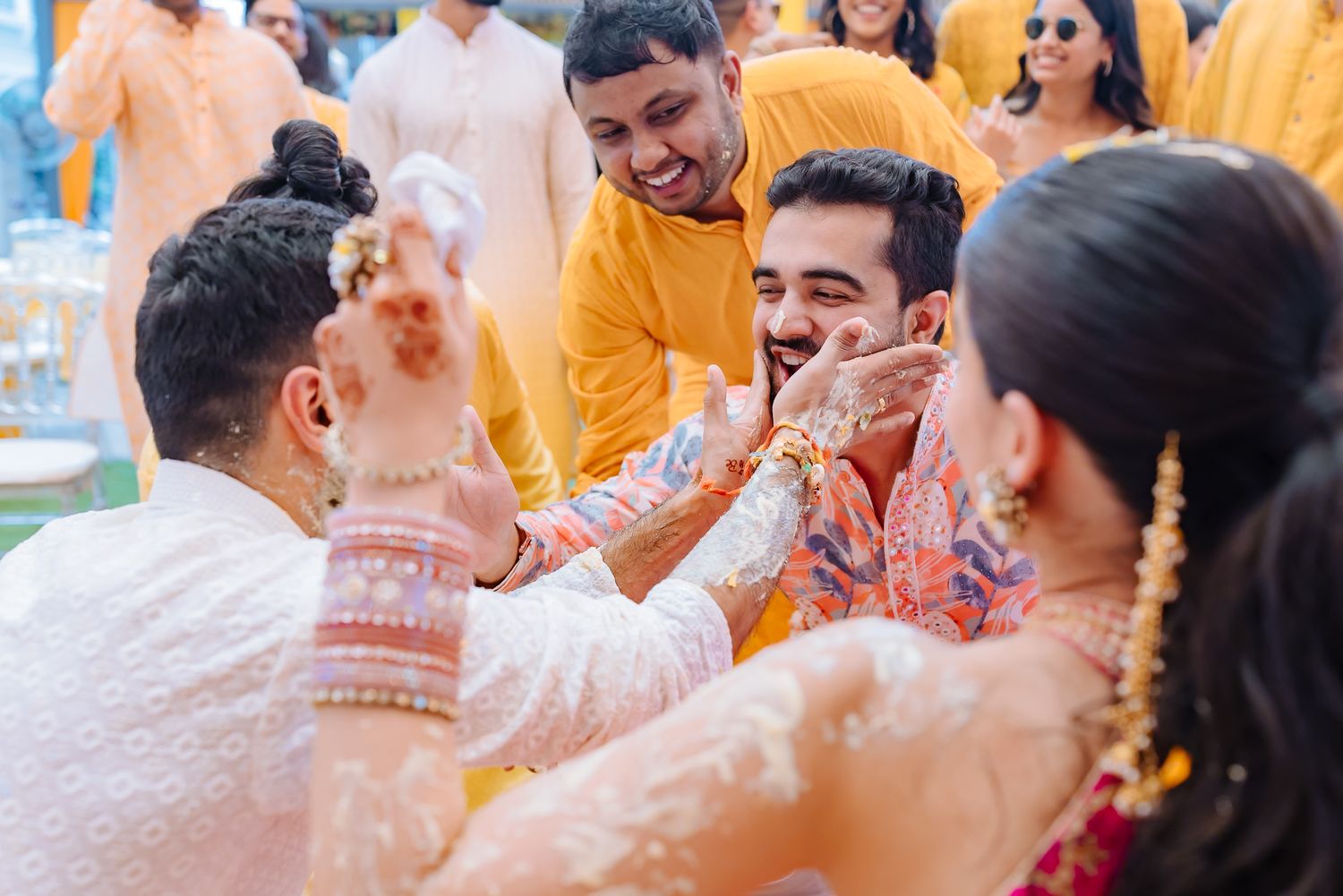 Wedding guests applying haldi and blessing Shorye and Leah at Tivoli Chattarpur