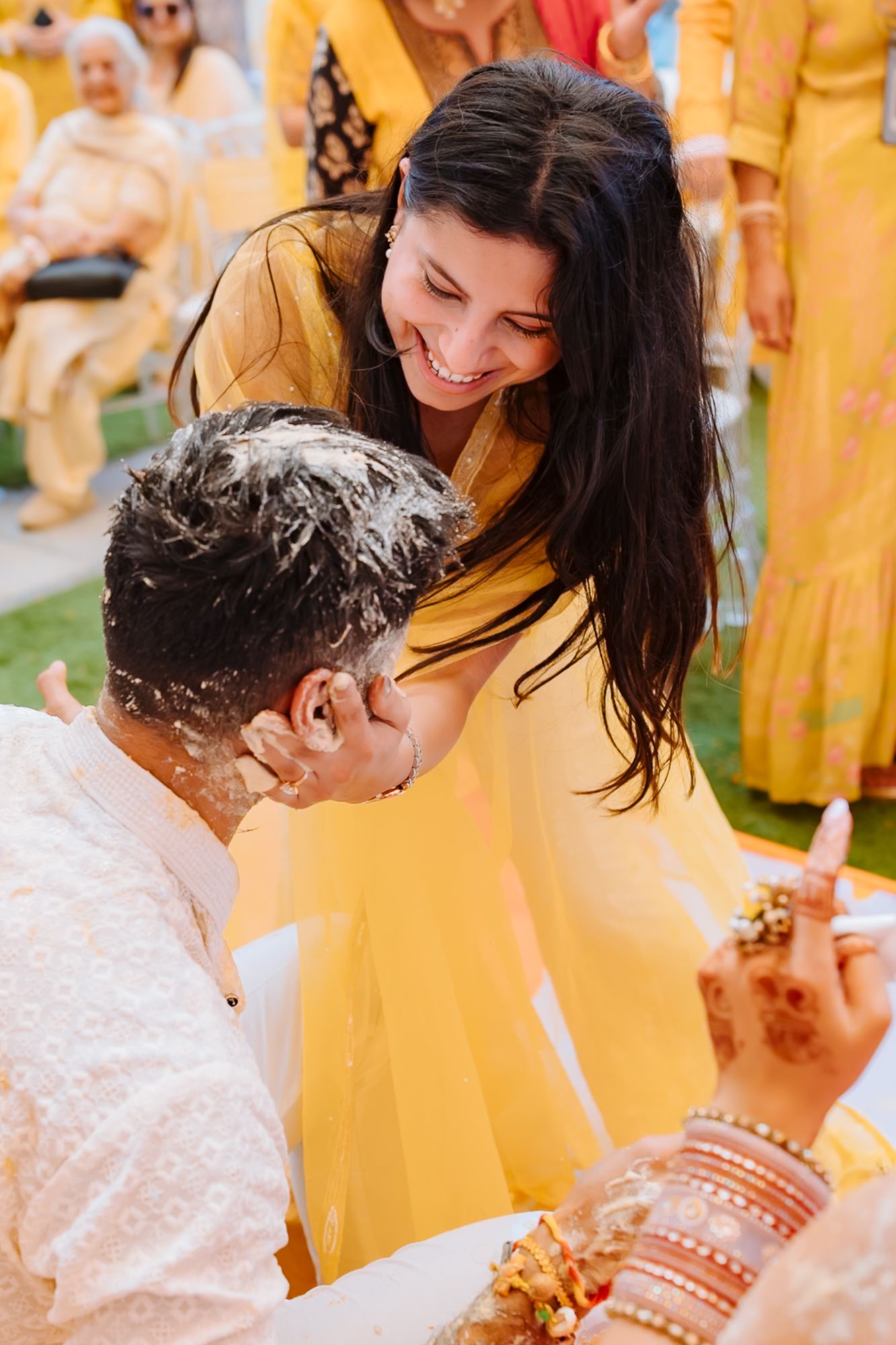 Shorye and Leah sharing a candid Haldi moment with their wedding guests at Tivoli Chattarpur