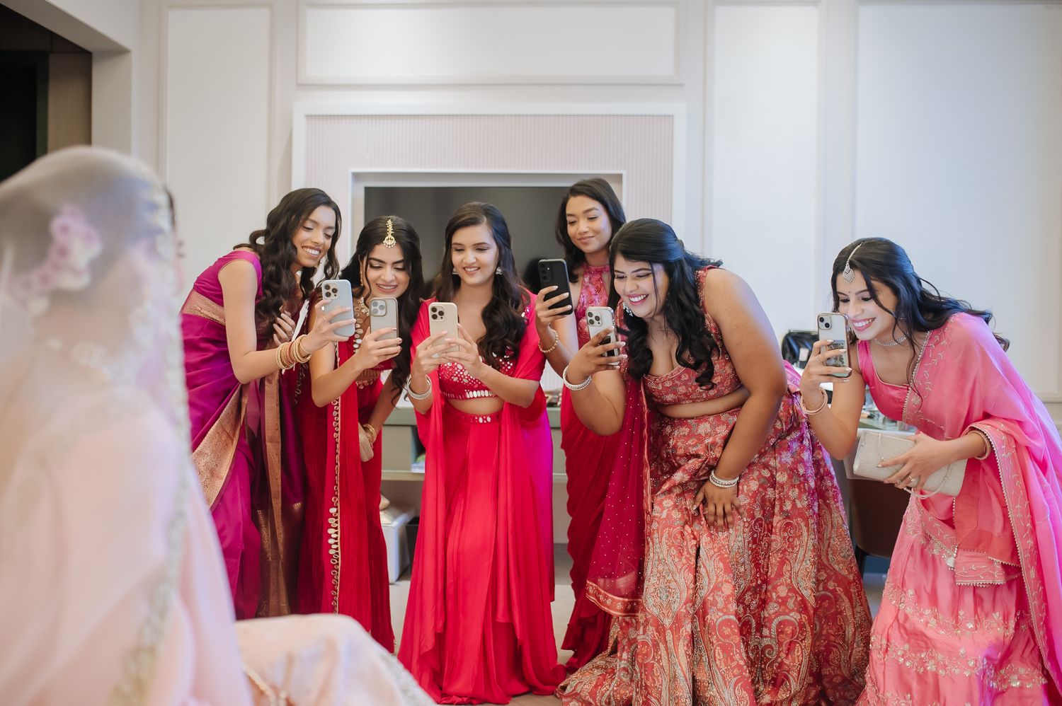 Leah’s radiant bridal portrait with her bridesmaids in magenta at Tivoli Chattarpur