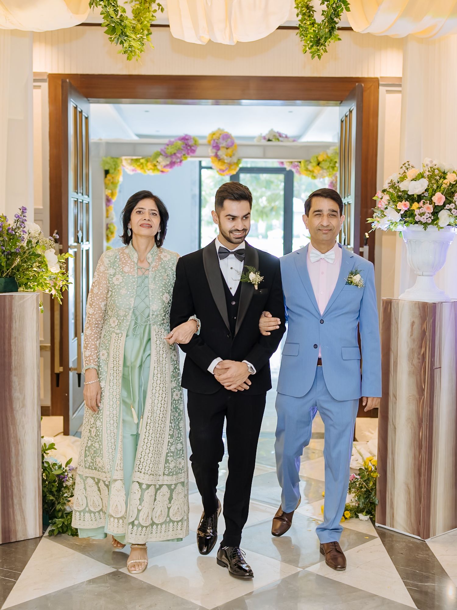 Shorye walking down the aisle with his parents during her Christian wedding ceremony at Tivoli Chattarpur