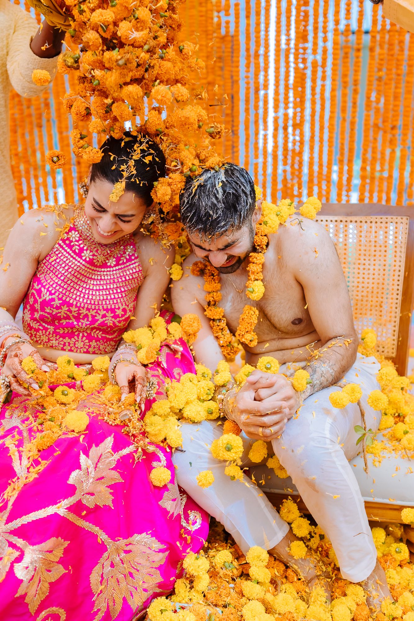 Colourful flower petals raining over Shorye and Leah during the Haldi at Tivoli Chattarpur