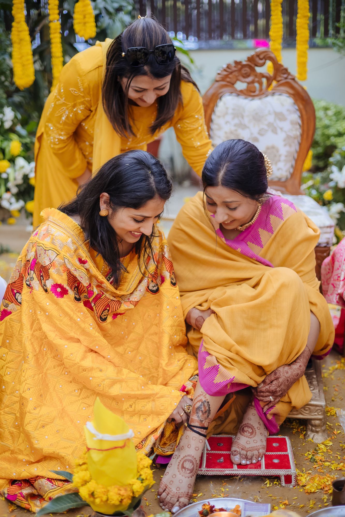 Family blessing the bride during the Punjabi Chooda ceremony during her indo-norwegian wedding in Chandigarh