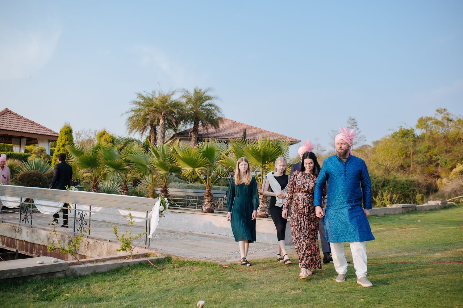 Family celebrating the groom's arrival with music and dancing for an Indo-Norwegian fusion wedding in Forest Hill Chandigarh