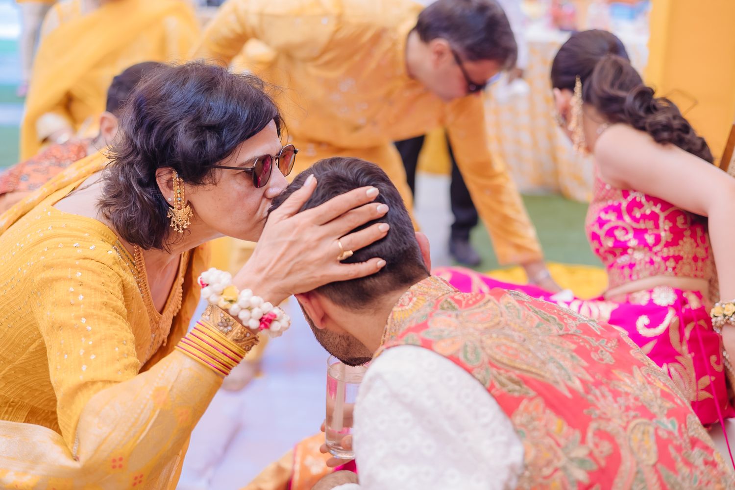 Family member sharing a personal haldi moment with Shorye and Leah at Tivoli Chattarpur
