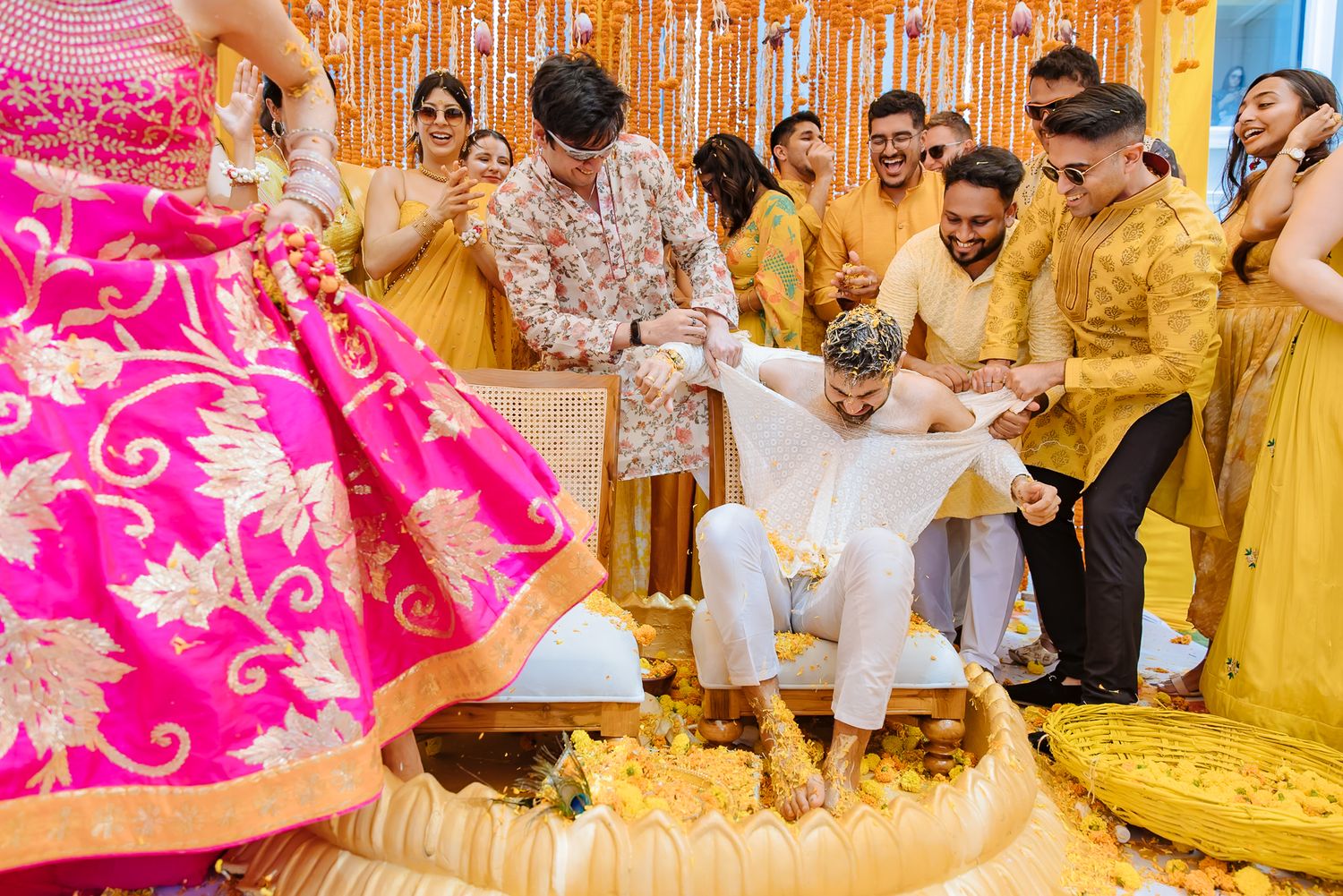 Family and friends playfully tearing Shorye’s kurta during the Haldi at Tivoli Chattarpur