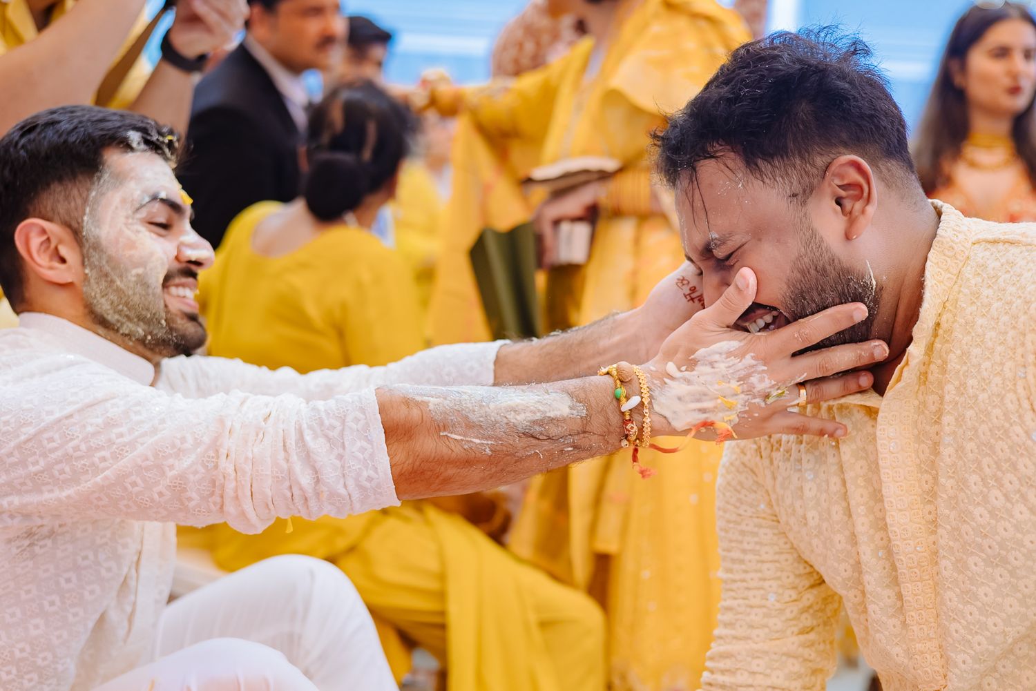 Guests applying haldi to Shorye and Leah during their Haldi ceremony at Tivoli Chattarpur