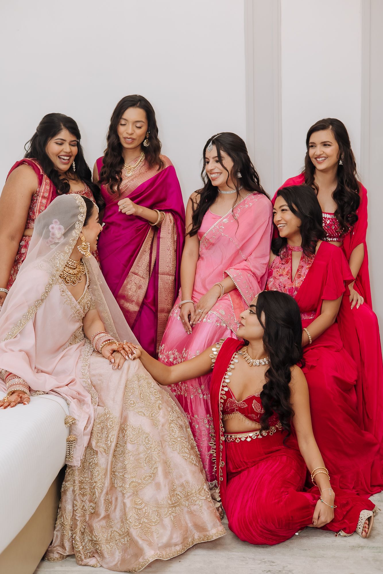 Leah’s radiant bridal portrait with her bridesmaids in shades of pink at Tivoli Chattarpur