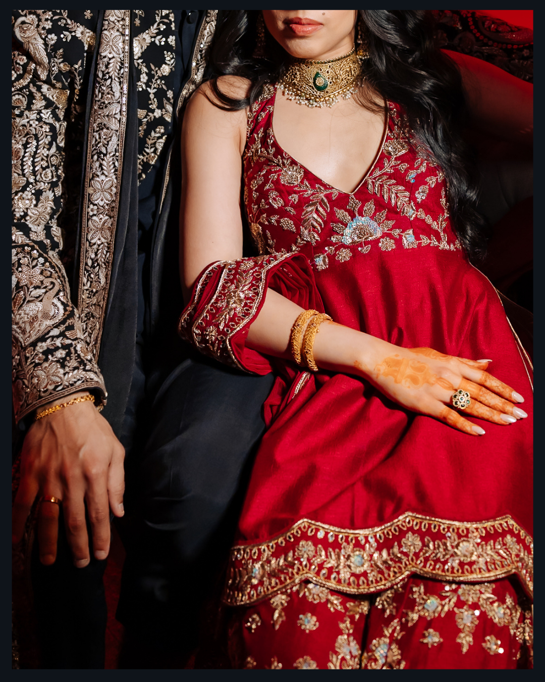 Bride and groom Shorye and Leah dressed in black and red for their Indian wedding Sangeet at Tivoli Chattarpur