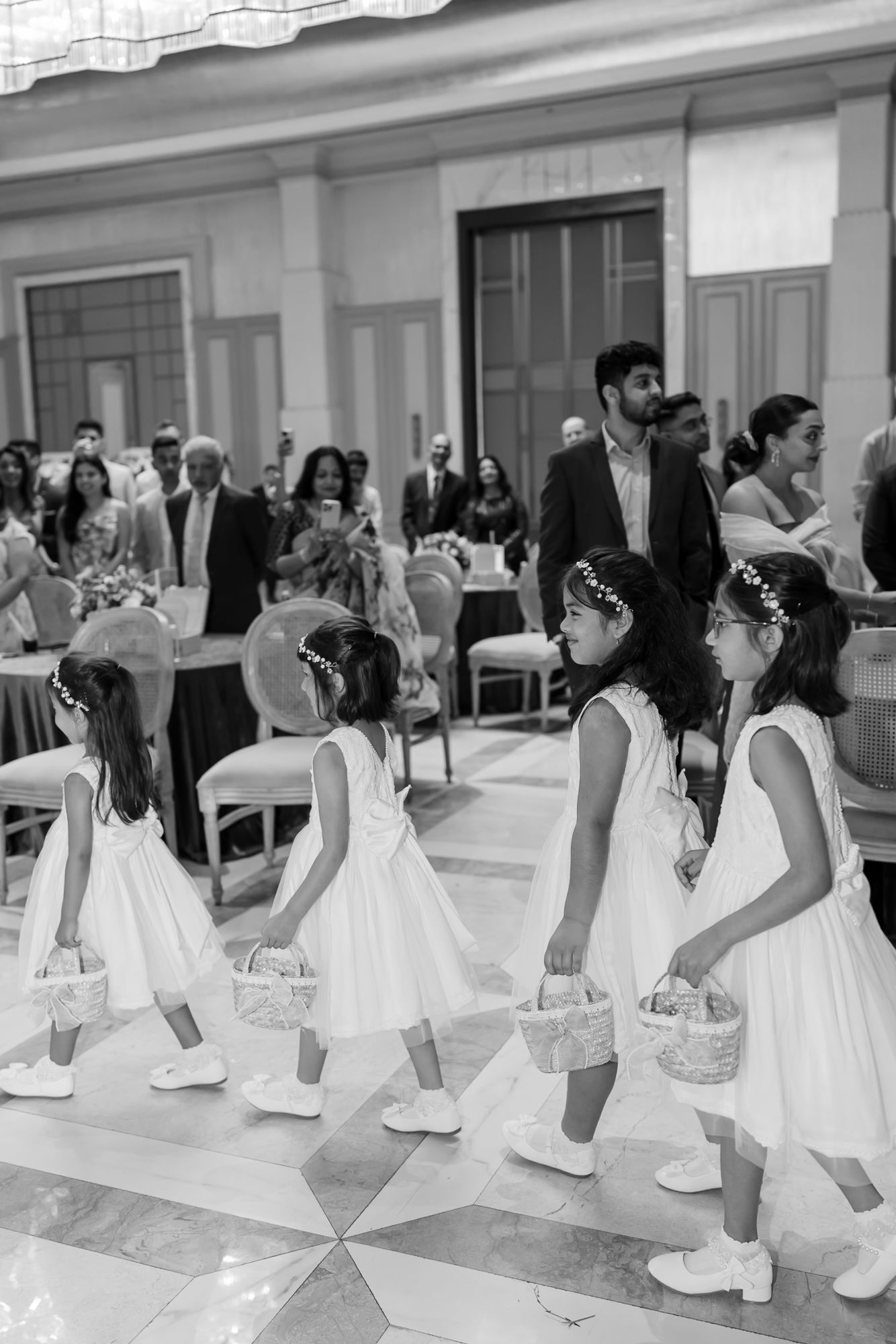 Flowergirls walking down the aisle during Shorye and Leah's Christian wedding ceremony at Tivoli Chattarpur