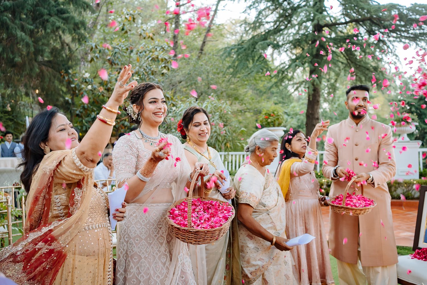 Guests throwing flowers at Bride and groom at Varmala at an intimate wedding of 30 guests in the Himalayas at Daleside Manor, Kasauli