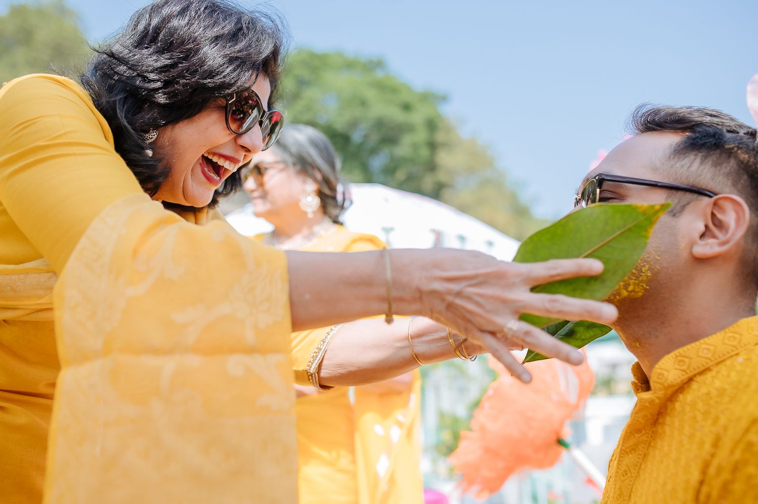 Colorful and candid Haldi moments captured by Fine-art and candid Indian wedding photography and films team Beginnings For You.