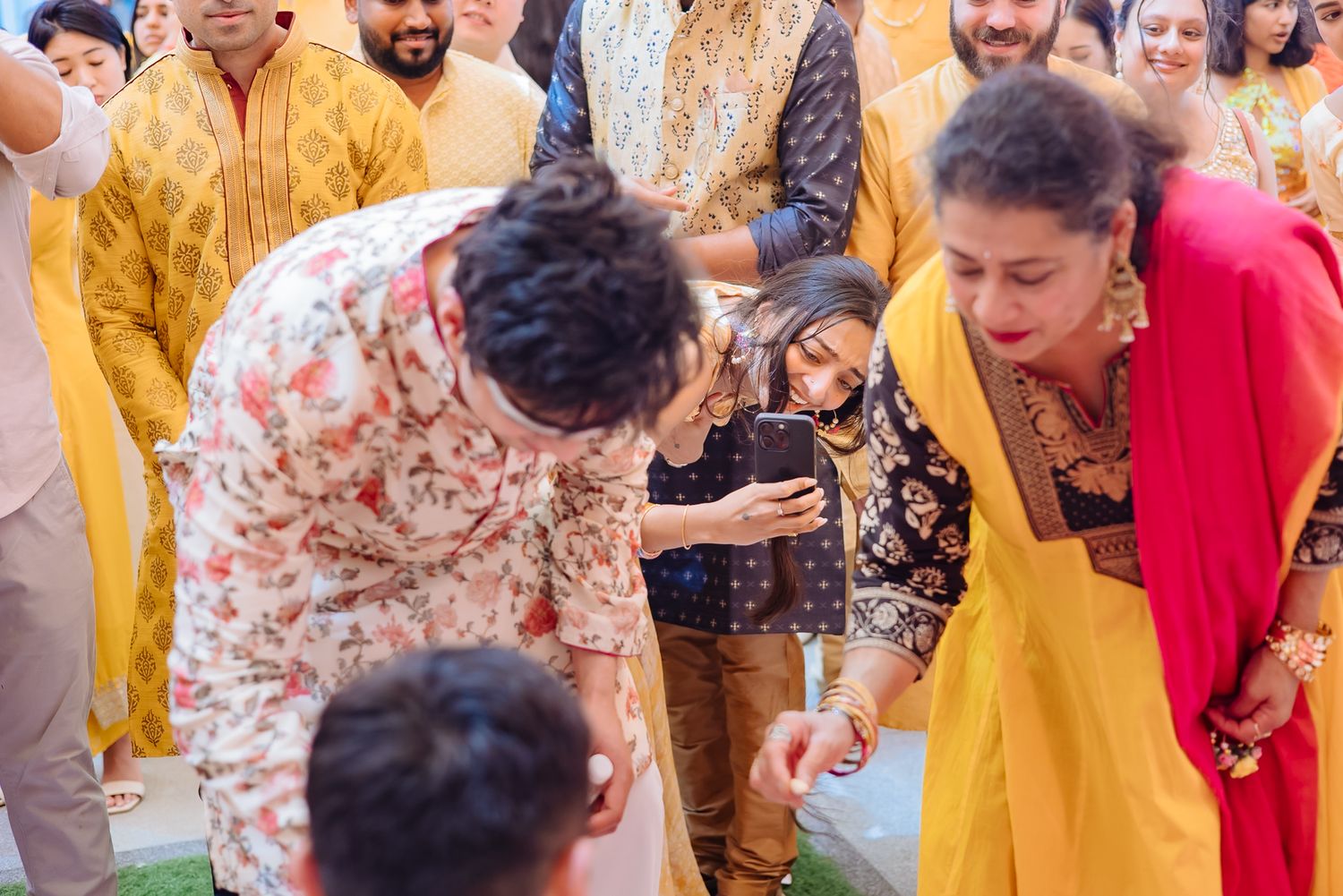 Guests applying haldi to Shorye and Leah during their Haldi ceremony at Tivoli Chattarpur