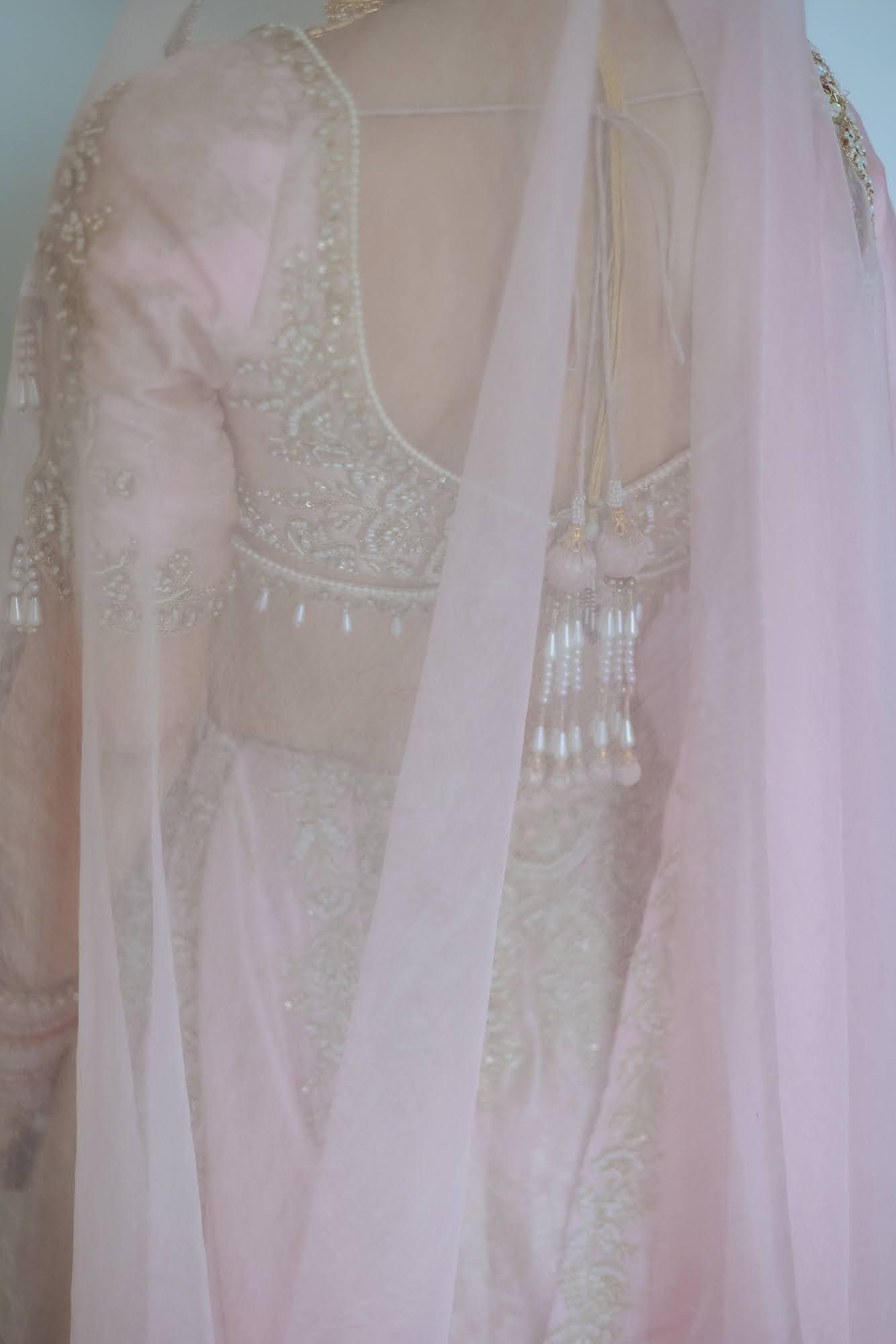 Bride Leah embracing a soft pastel bridal palette for her Punjabi wedding at Tivoli Chattarpur