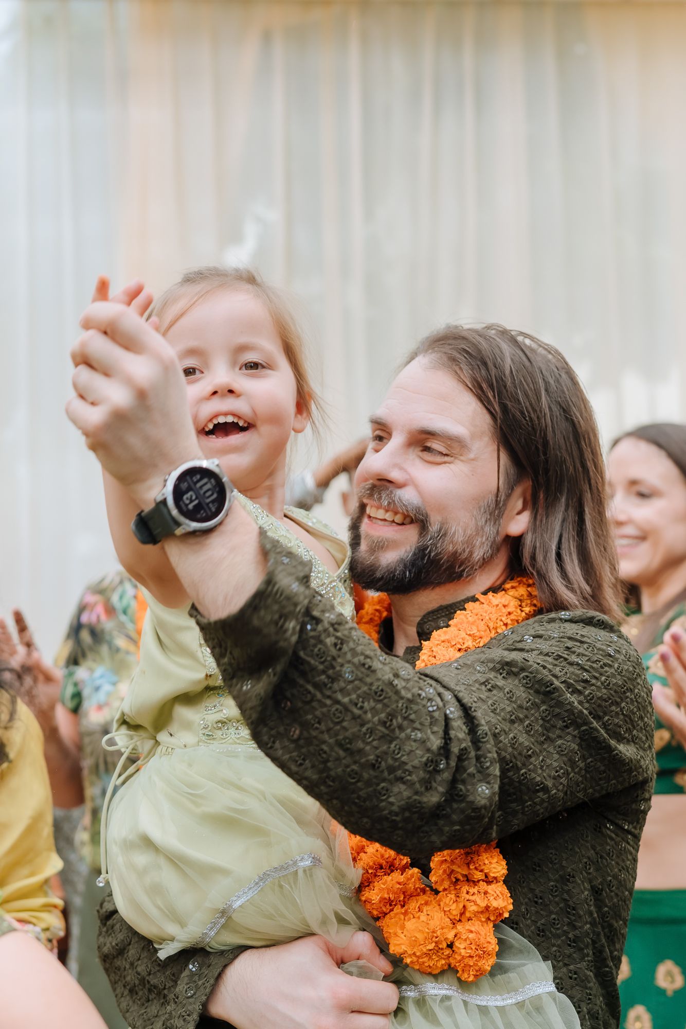 Family dancing together during the Mehendi celebrations at an Intimate home wedding moments before the wedding festivities begin
