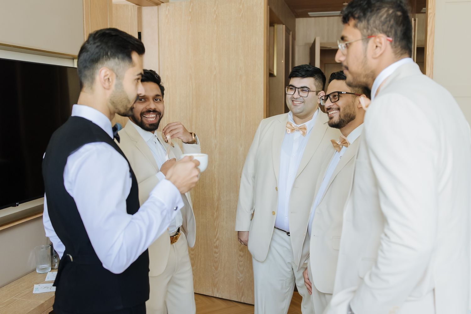 Groom and groomsmen sharing candid moments before the wedding at Tivoli Chattarpur.