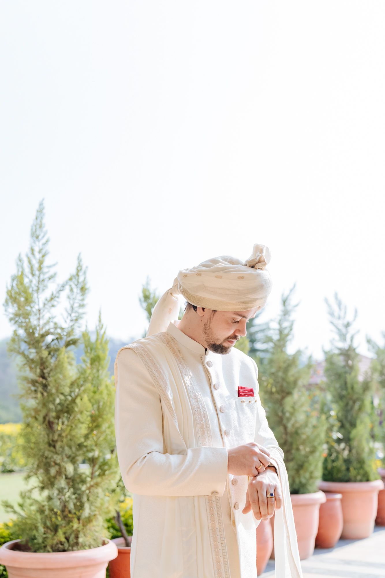 Groom Mats wearing an ivory sherwani before the wedding ceremony for his Indo-Norwegian wedding at Forest Hill, Chandigarh
