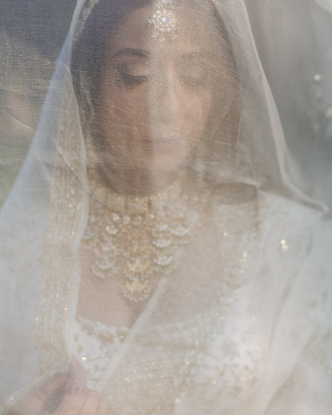 Elegant bridal portrait of Bride Itisha in an ivory lehenga for an intimate Indo-Norwegian wedding in Forest Hill, Chandigarh