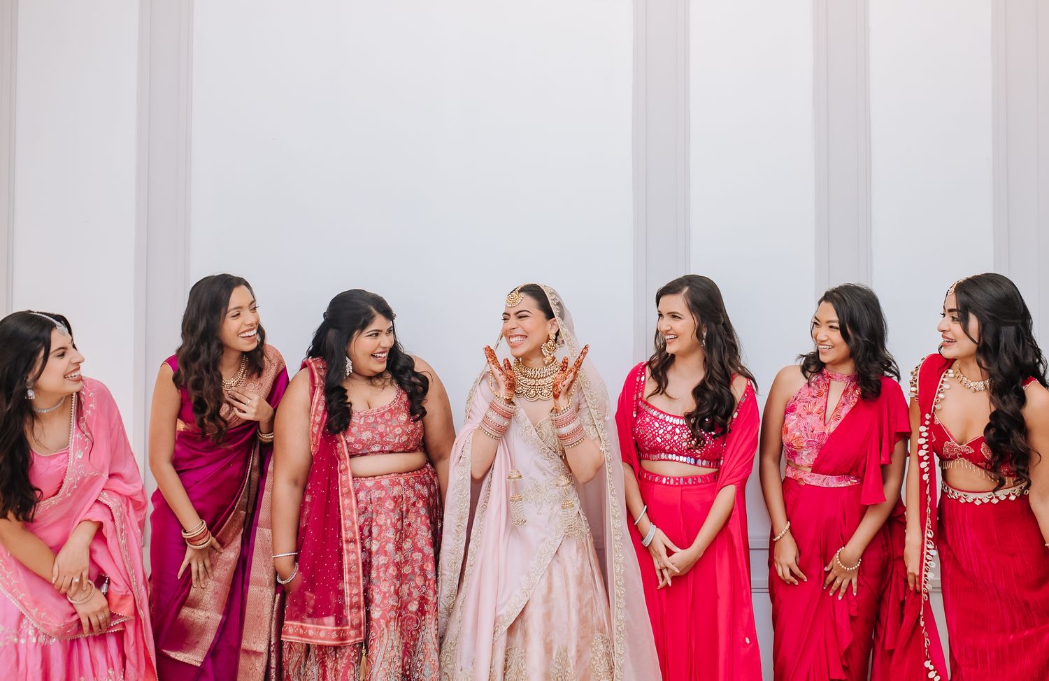 Leah’s radiant bridal portrait with her bridesmaids in shades of pink at Tivoli Chattarpur