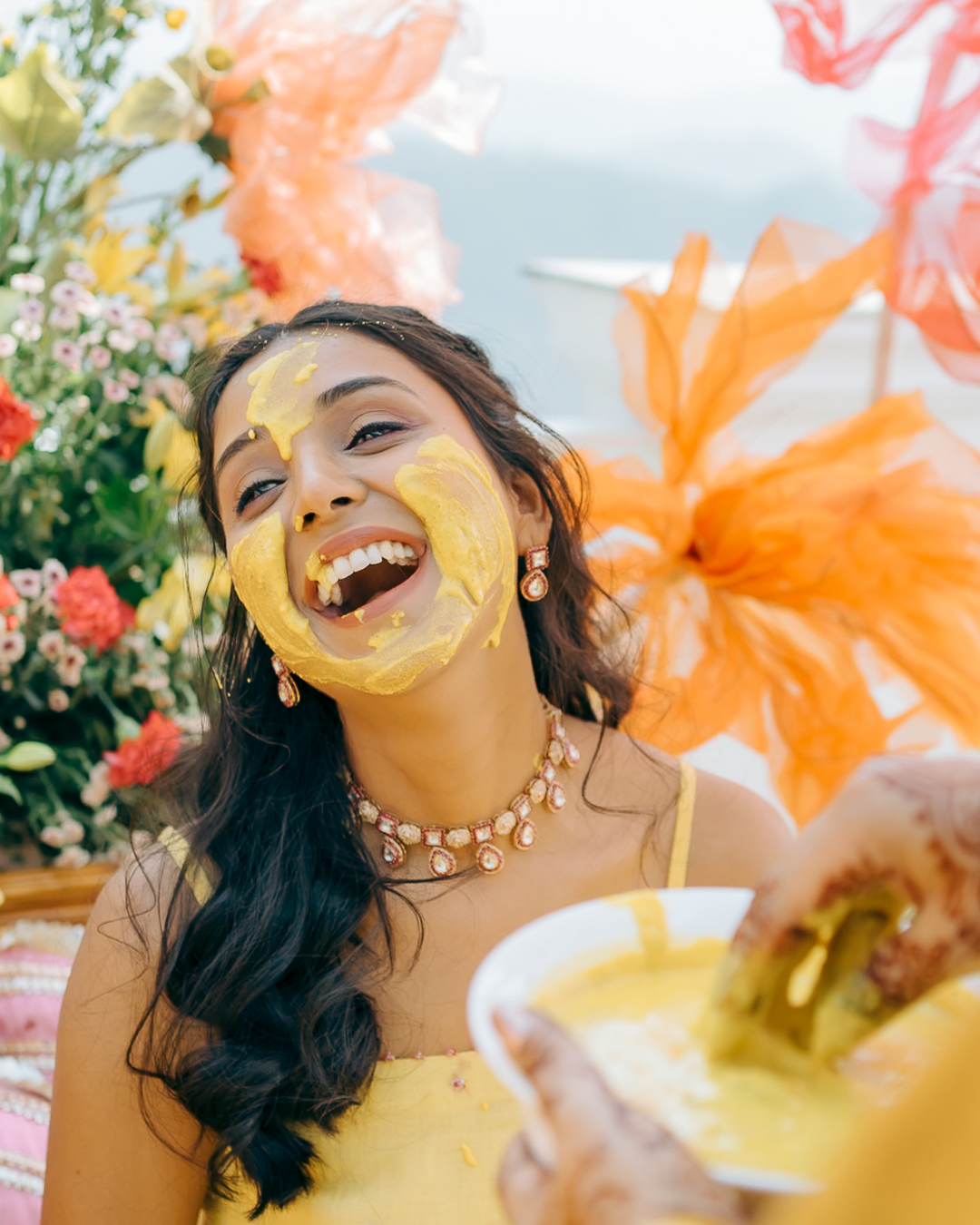 Colorful and candid Haldi bride captured by Fine-art and candid Indian wedding photography and films team Beginnings For You.