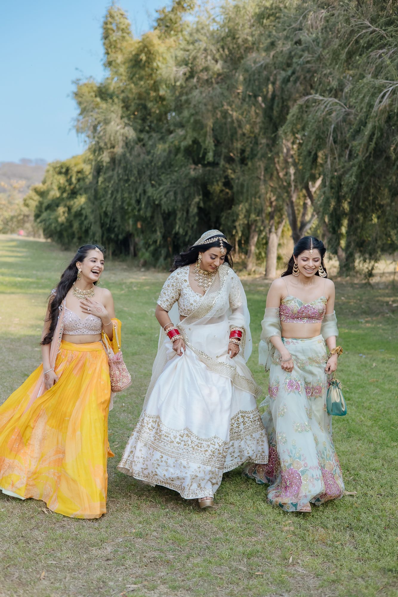 Elegant bridal portrait of Bride Itisha in ivory lehenga with bridesmaids for an intimate Indo-Norwegian wedding in Forest Hill, Chandigarh