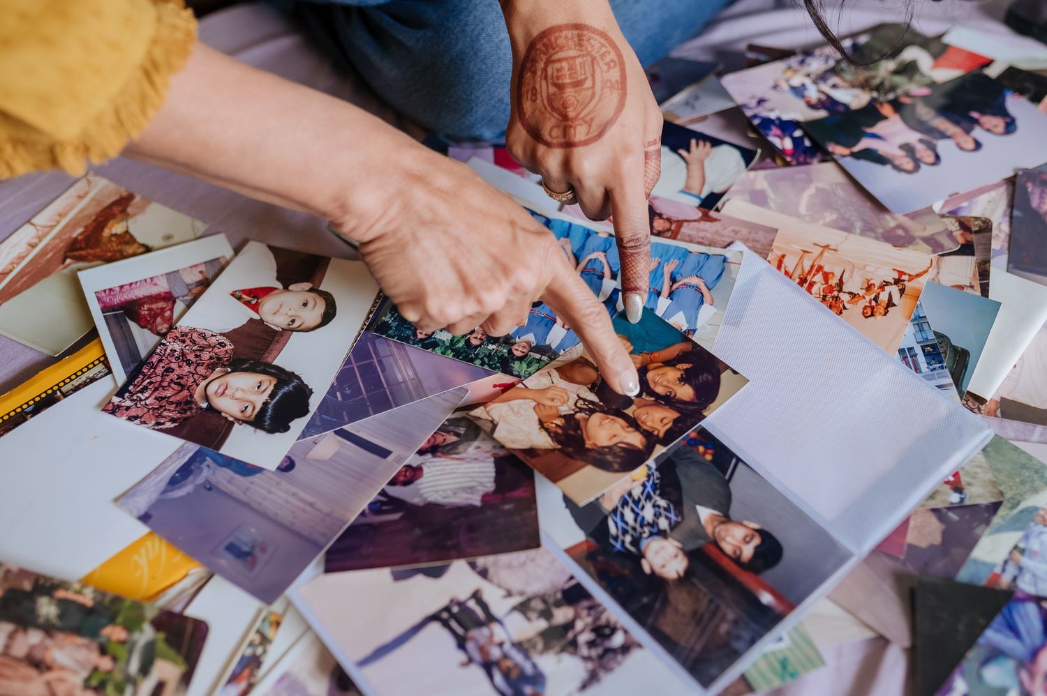Emotional mother-daughter moment with vintage family photographs on the wedding morning by Storytelling wedding photography