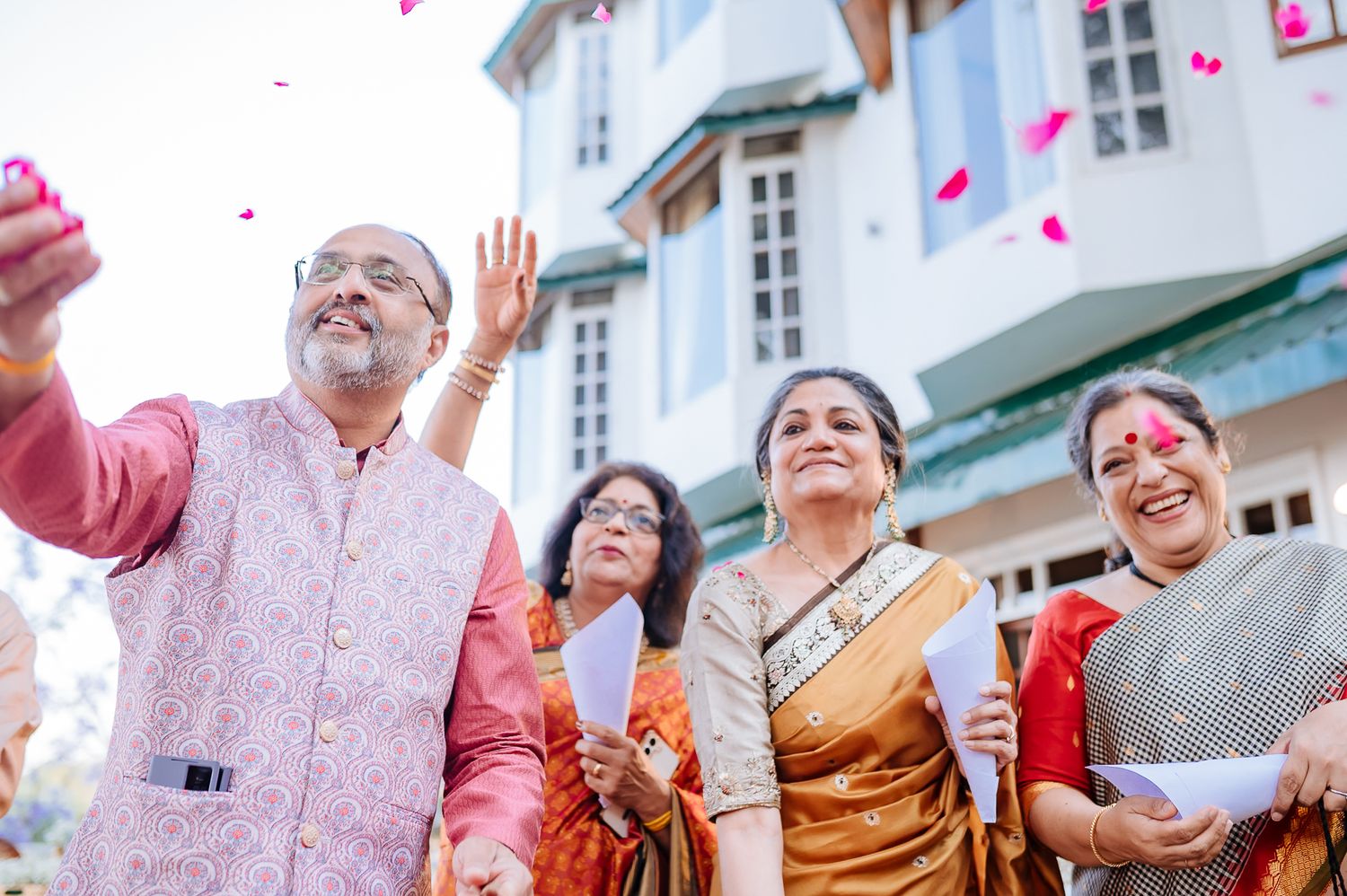 friends and family throwing flowers at bride and groom at an intimate wedding of 30 guests in the hills at Daleside Manor Kasauli