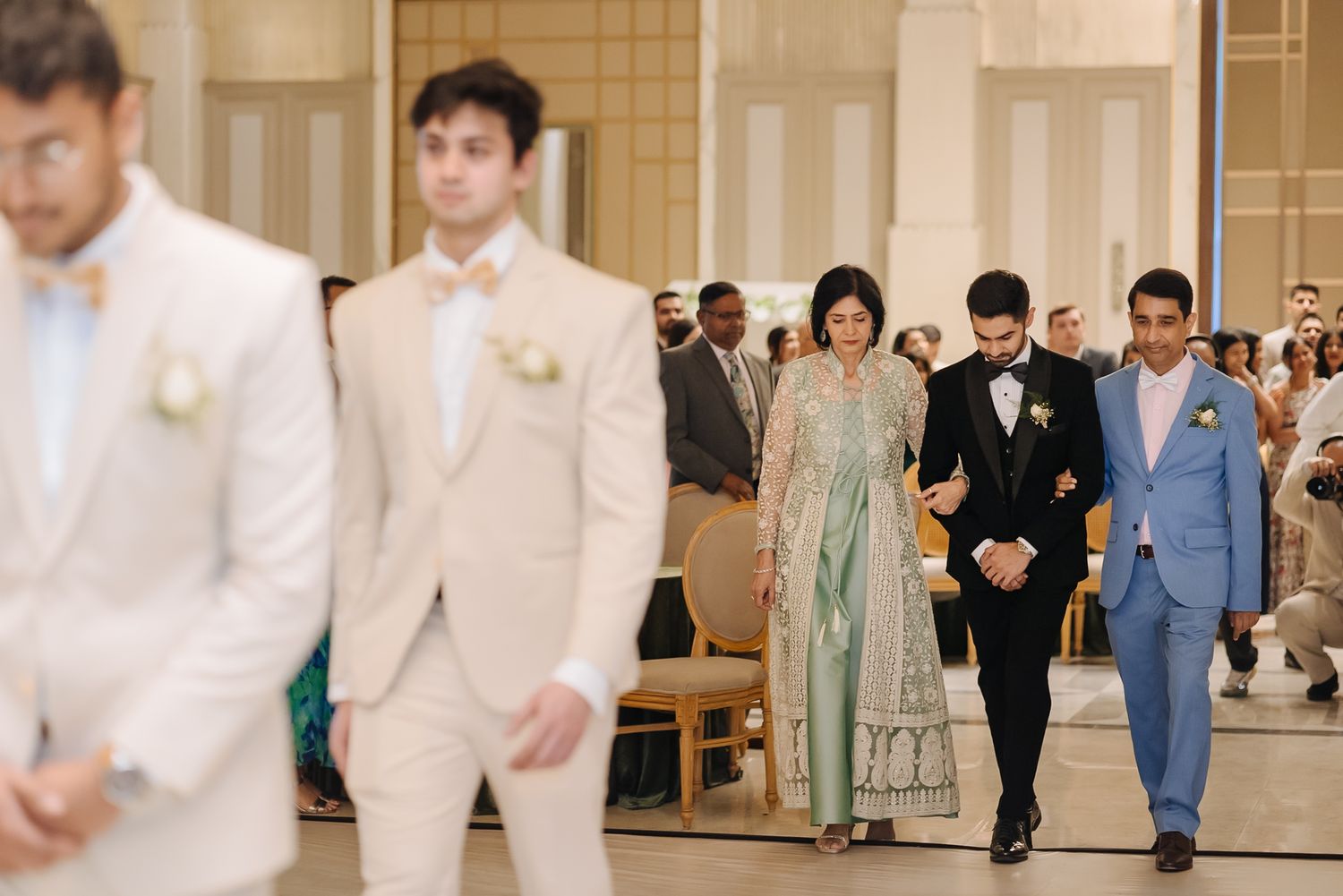 Groom Bridal Party walking down the aisle with his parents during her Christian wedding ceremony at Tivoli Chattarpur