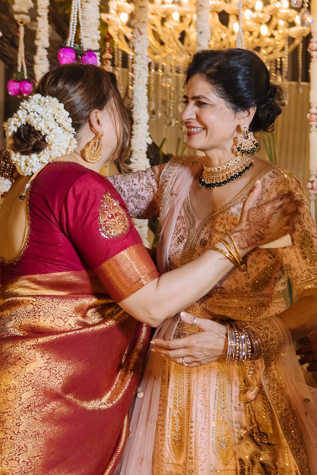 Family reacting joyfully to Shorye and Leah’s varmala ceremony at Tivoli Chattarpur
