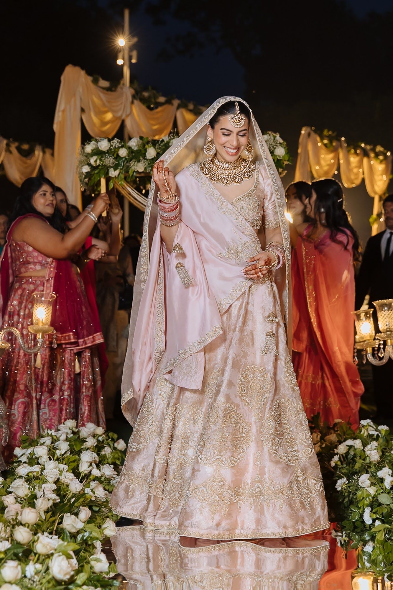 Pastel pink bride Leah making her Indian wedding entrance at Tivoli Chattarpur
