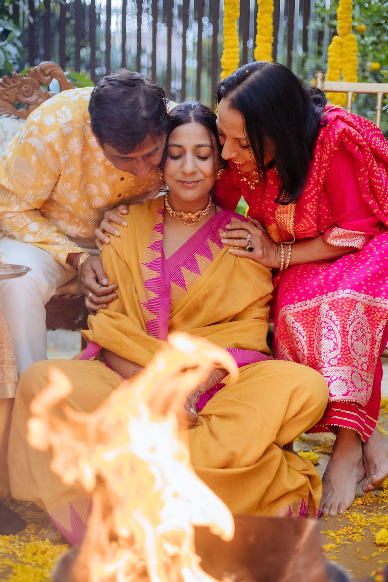 Family blessing the bride during the Punjabi Chooda ceremony during her indo-norwegian wedding in Chandigarh
