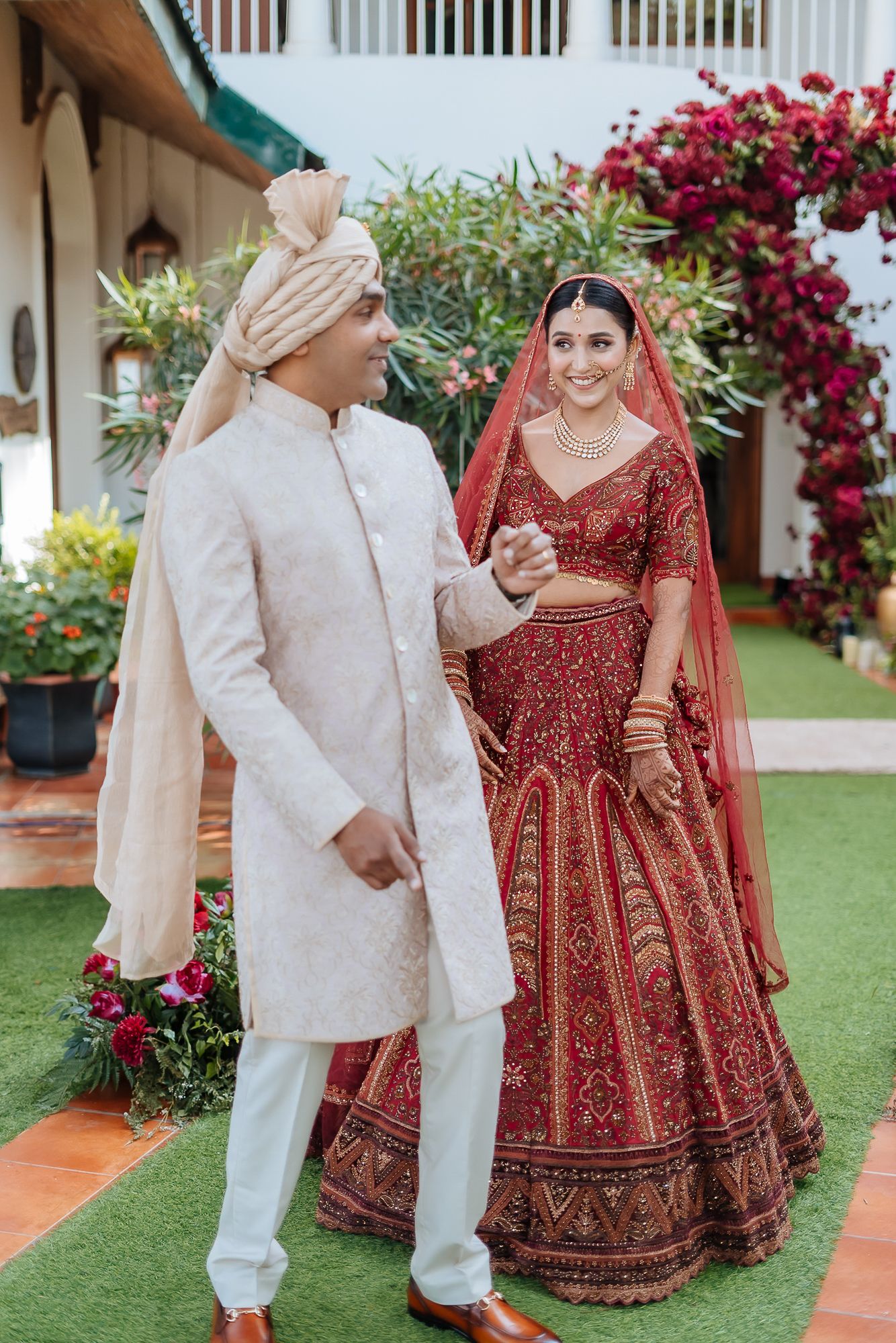 Bride in deep red lehenga during candid first look at Daleside Manor Kasauli