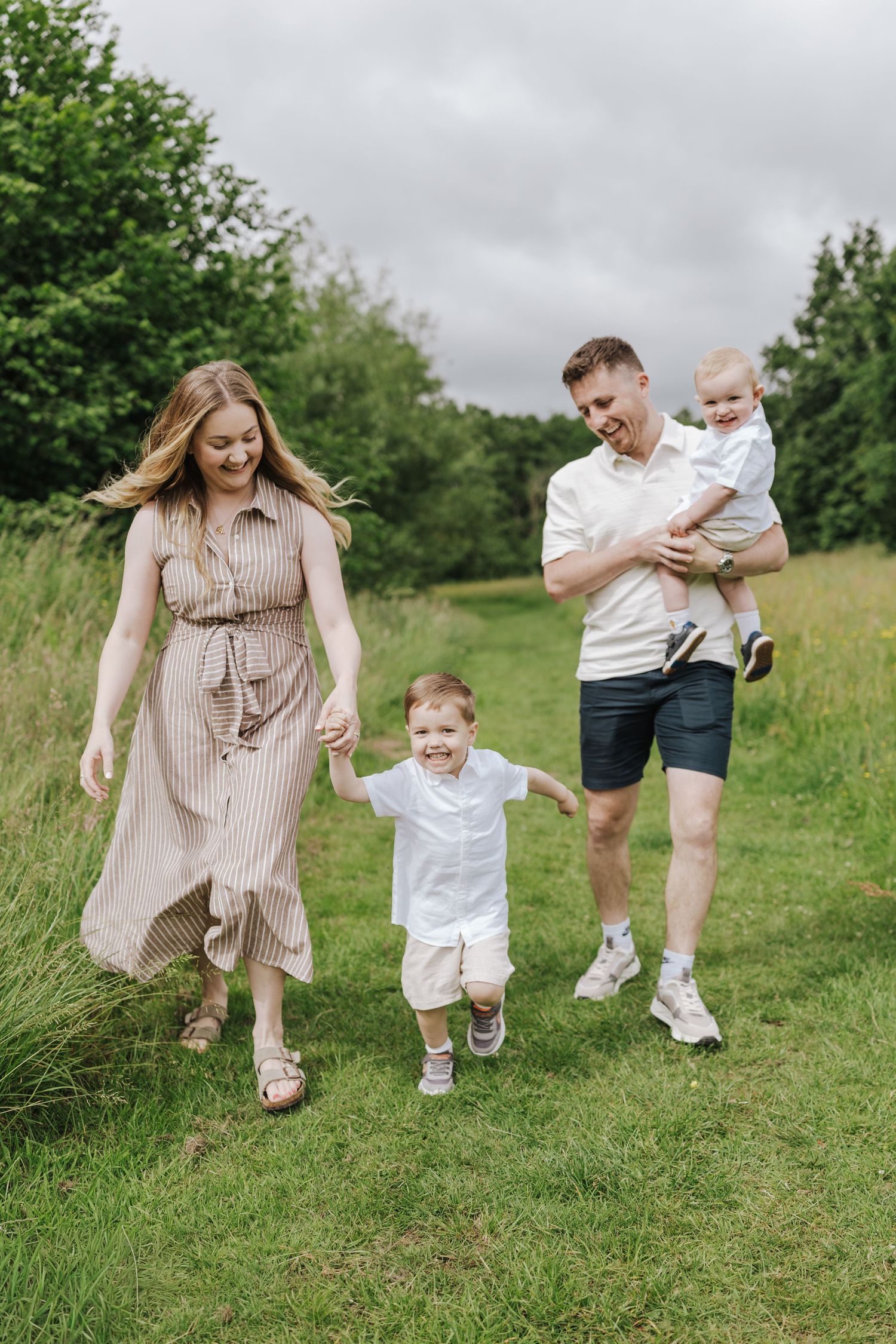 Mum and dad with their two sons during summer family photoshoot in Telford