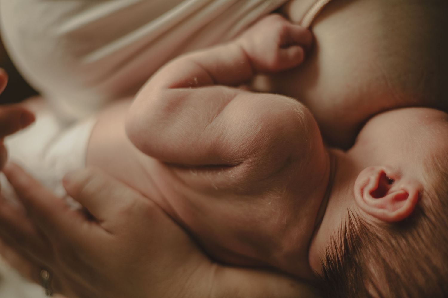 A photo of a mother breastfeeding her son.