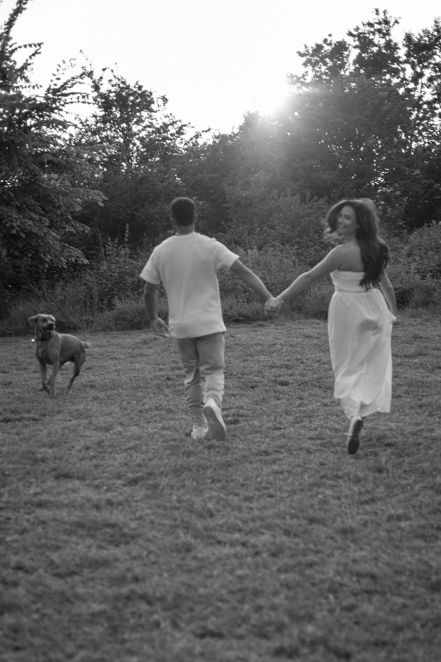 Couple running with their dog during photoshoot in Telford.