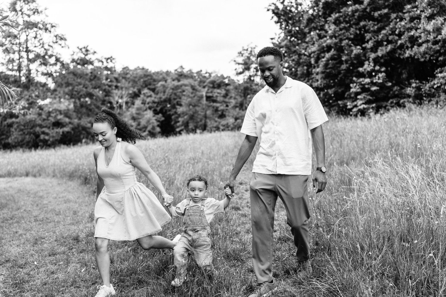 Mum and dad with their son during summer family photoshoot in Telford