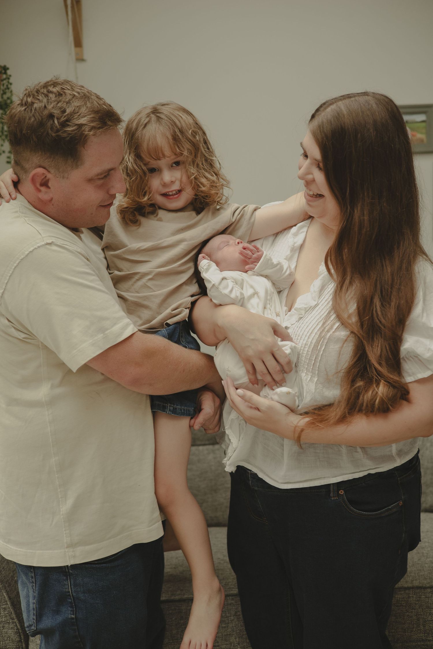 Photo of a family of four during newborn photography session in Telford.