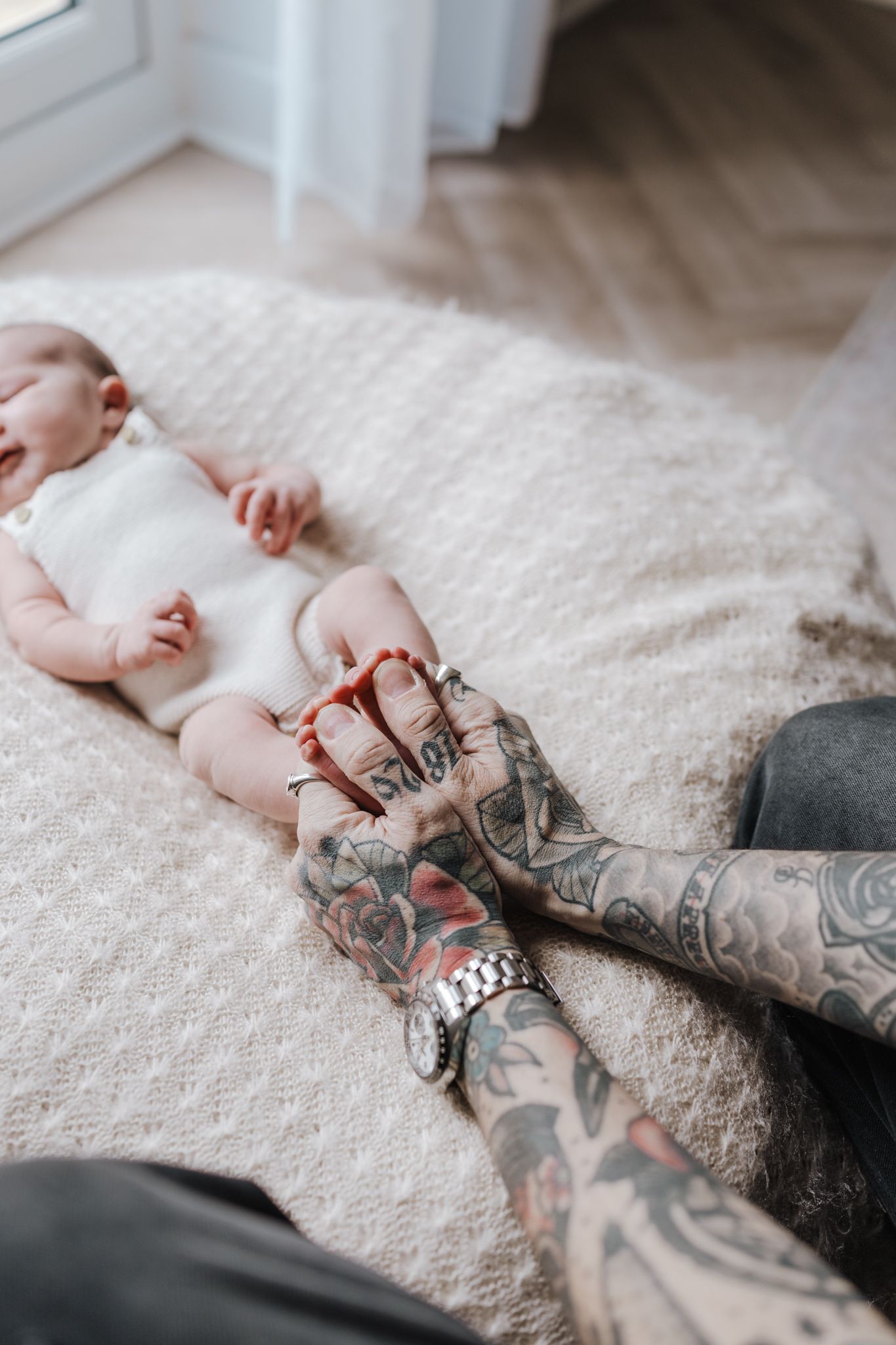 Dad holding babies feet during newborn photoshoot in Telford
