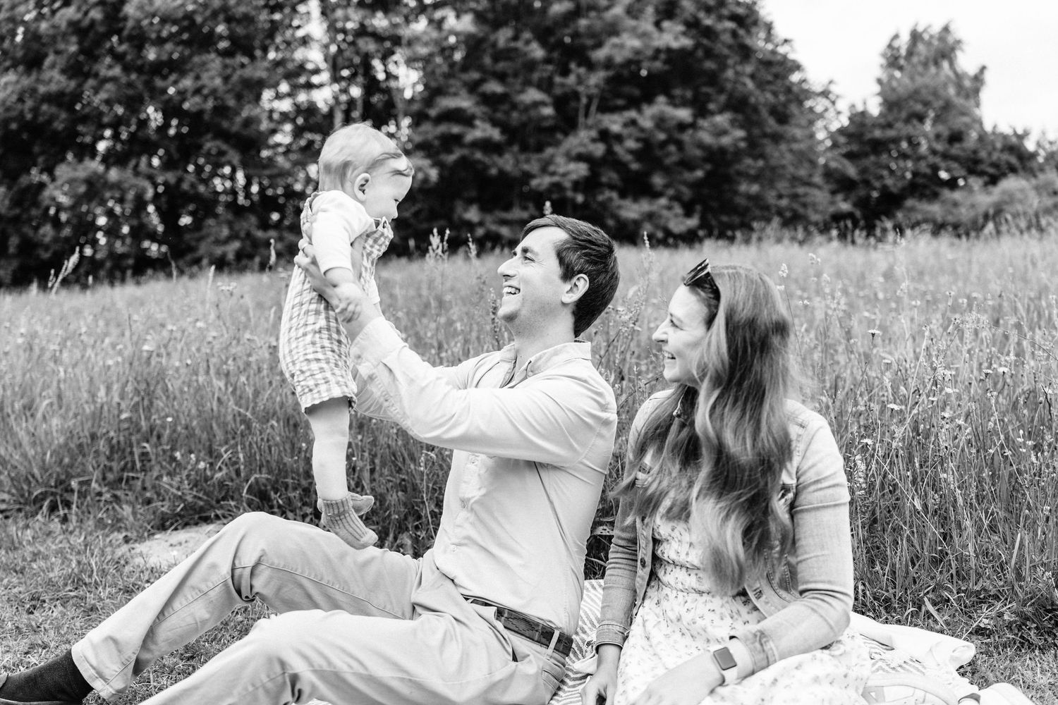 Mum and dad with their son during summer family photoshoot in Telford