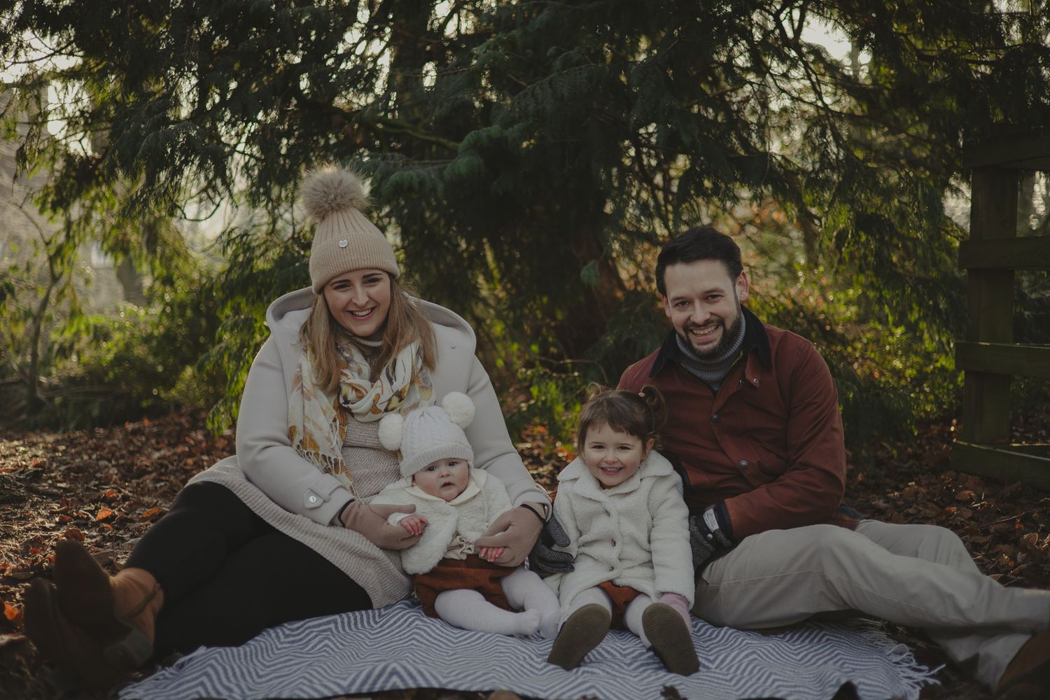 Family of four looking happy during family photoshoot in Shropshire.