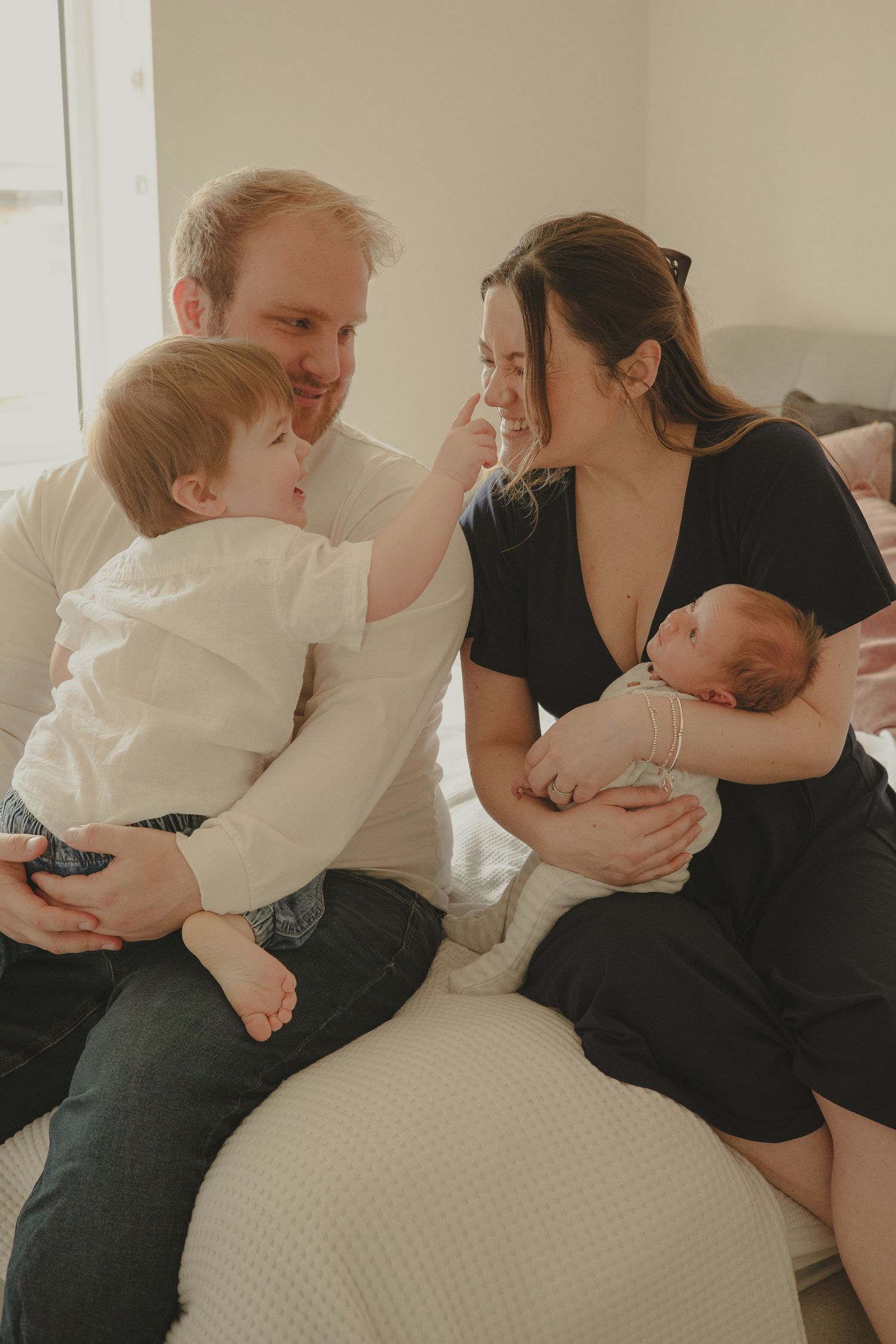 A family of four playing happily during family photoshoot in Shrewsbury, Shropshire.