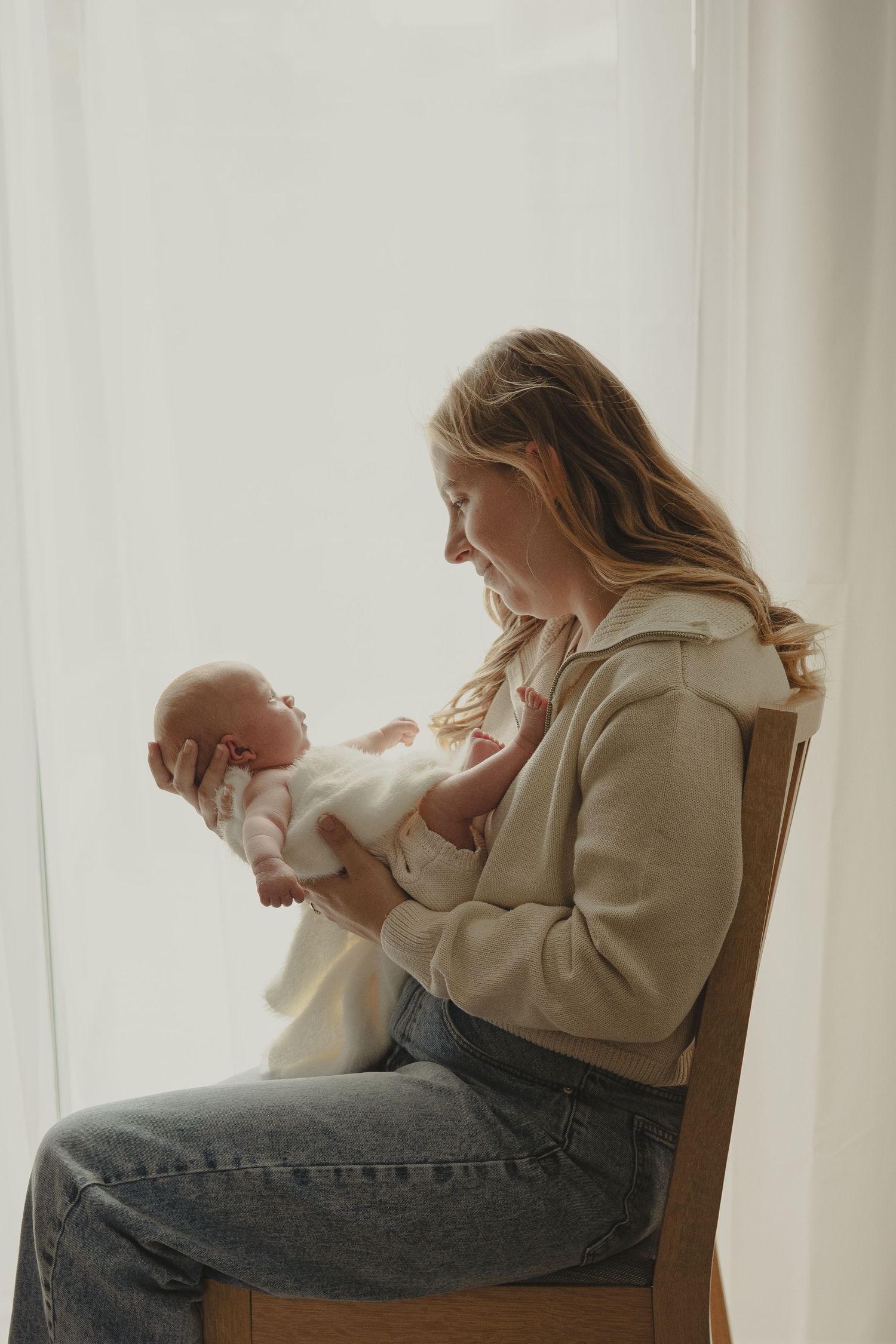 A picture of mum holding newborn during family photoshoot in Telford.
