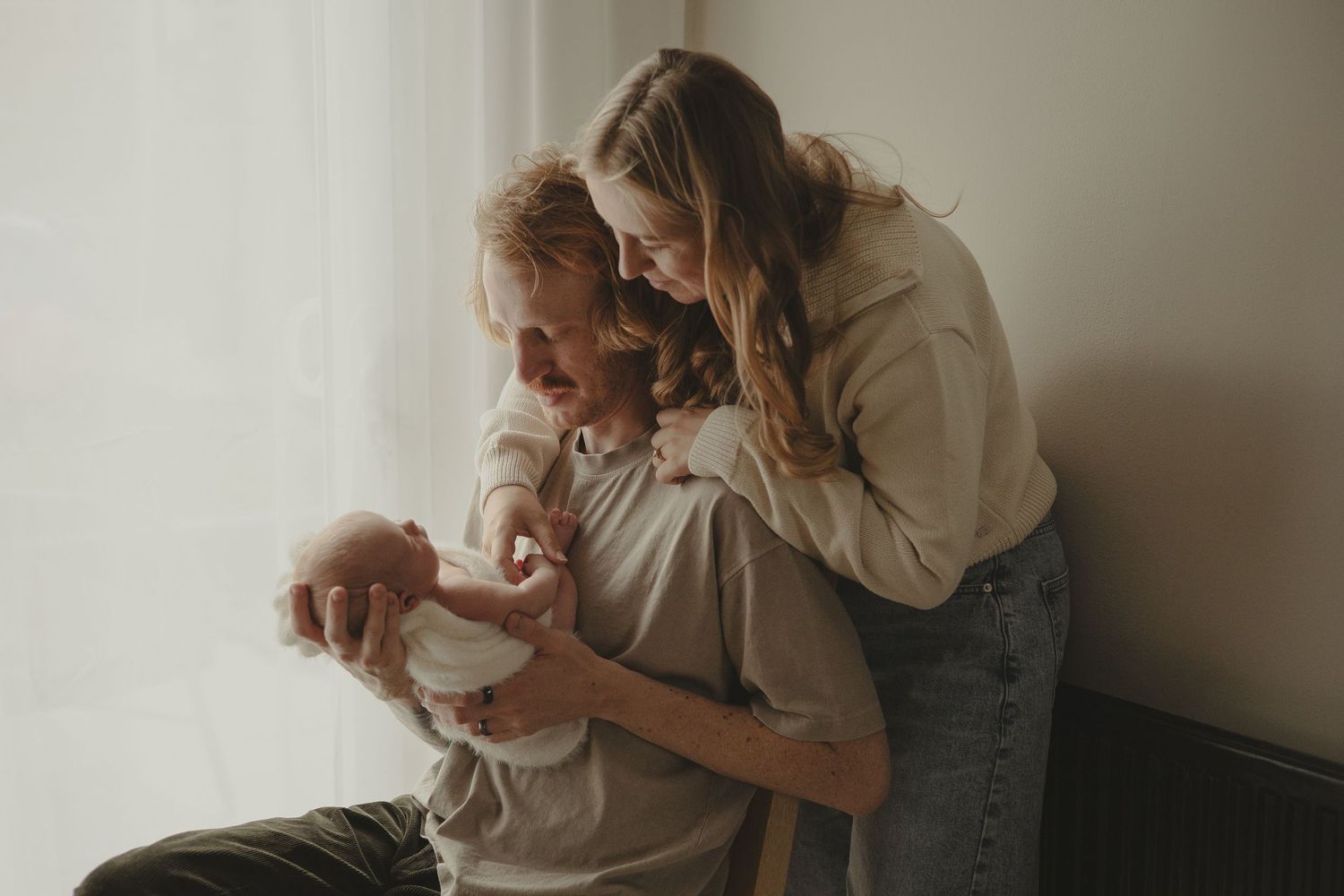 Photo of a family of three during newborn photography session in Telford.
